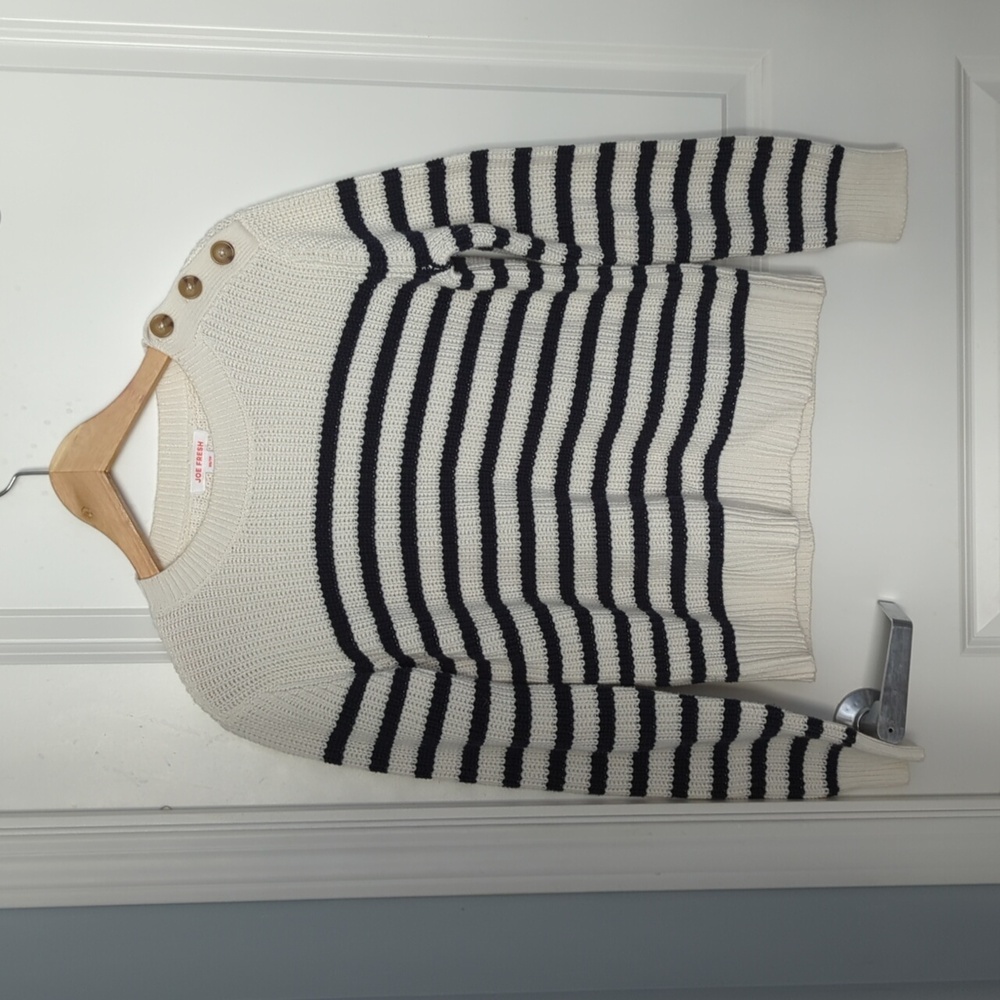 White and navy sweater with button detailing on shoulder